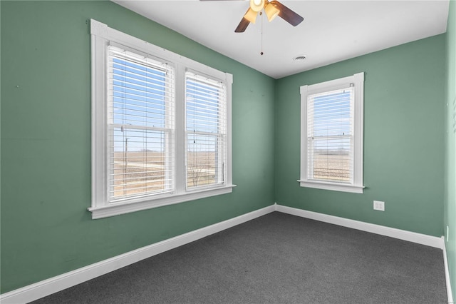 carpeted spare room with ceiling fan