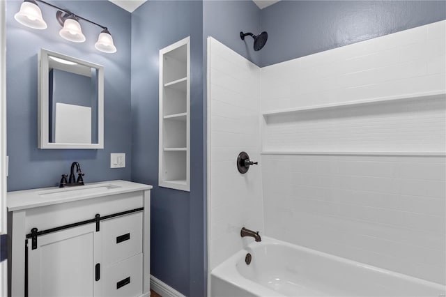 bathroom with tiled shower / bath and vanity