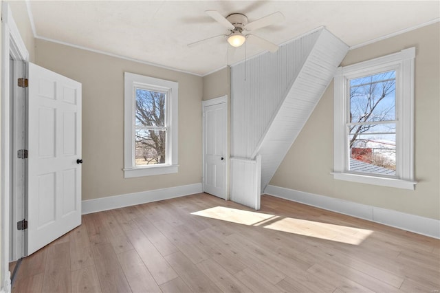 bonus room with ceiling fan and light wood-type flooring