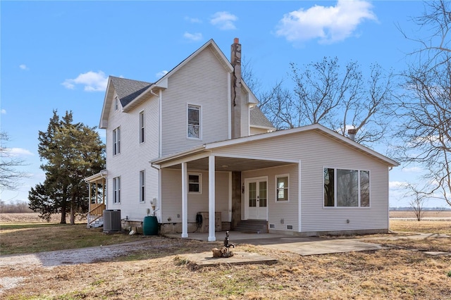 rear view of house with central AC unit and a patio area