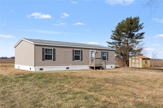 manufactured / mobile home featuring a front yard and a shed