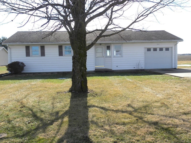 ranch-style house featuring a garage and a front lawn