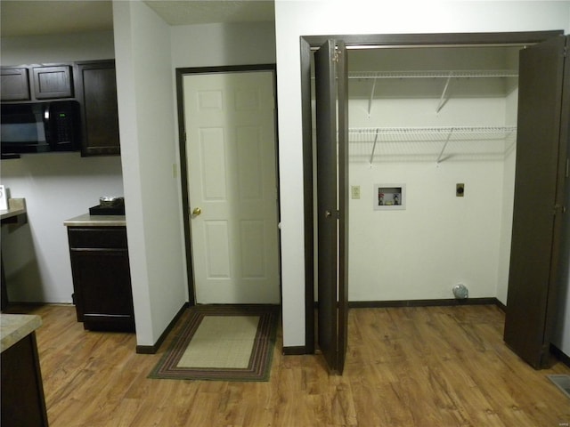 laundry room featuring hookup for a washing machine, hardwood / wood-style floors, and hookup for an electric dryer