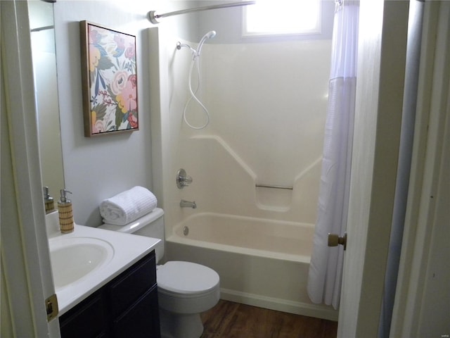 full bathroom with hardwood / wood-style flooring, shower / tub combo with curtain, vanity, and toilet