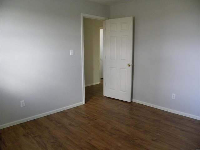 unfurnished room with dark hardwood / wood-style floors