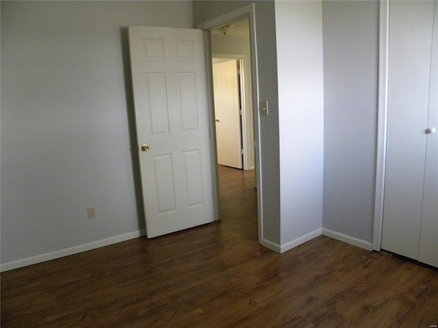 unfurnished bedroom featuring dark wood-type flooring