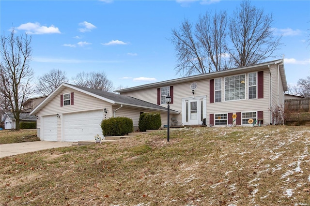 raised ranch with a garage and driveway