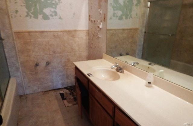 bathroom featuring tile walls and vanity