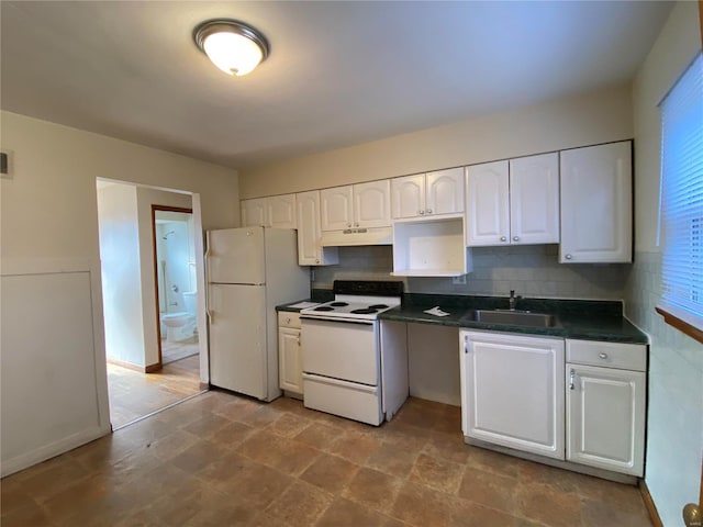 kitchen featuring sink, white appliances, white cabinets, and backsplash