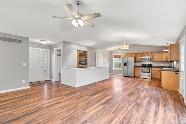 kitchen with sink, decorative light fixtures, dark hardwood / wood-style floors, and appliances with stainless steel finishes