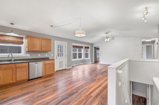 kitchen featuring lofted ceiling, sink, decorative light fixtures, dark hardwood / wood-style flooring, and dishwasher