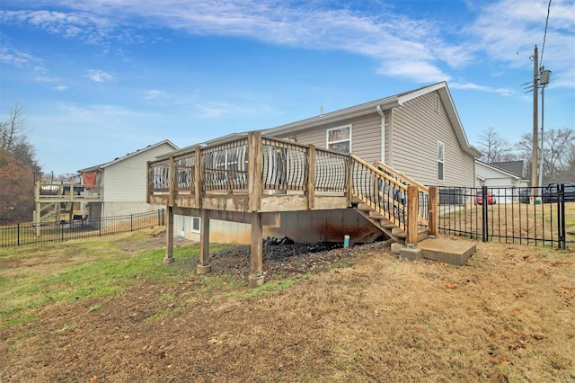 back of house with a yard and a deck