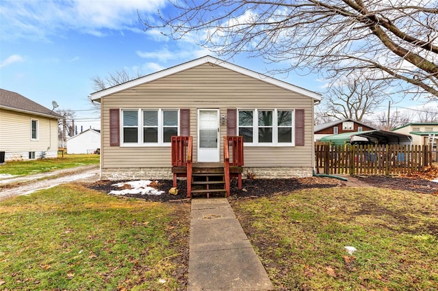 bungalow with a carport and a front lawn