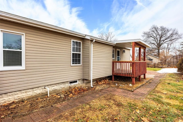 view of home's exterior featuring a wooden deck