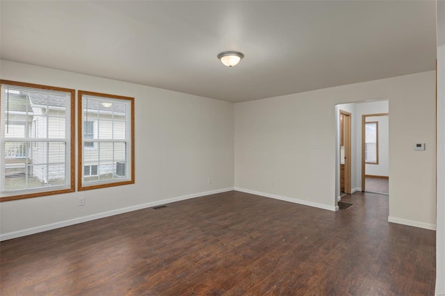 unfurnished room with dark wood-type flooring