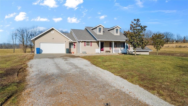 new england style home with a garage, covered porch, and a front lawn