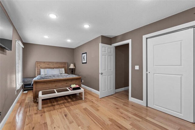 bedroom featuring a textured ceiling and light wood-type flooring