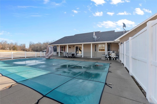 view of pool with a patio area and a water slide