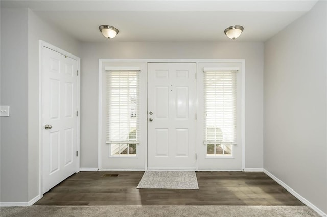 entryway featuring a wealth of natural light and dark hardwood / wood-style flooring