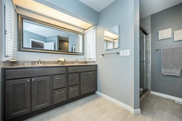 bathroom with walk in shower, vanity, and hardwood / wood-style floors