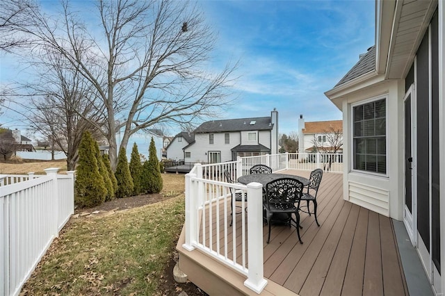 wooden deck with a lawn