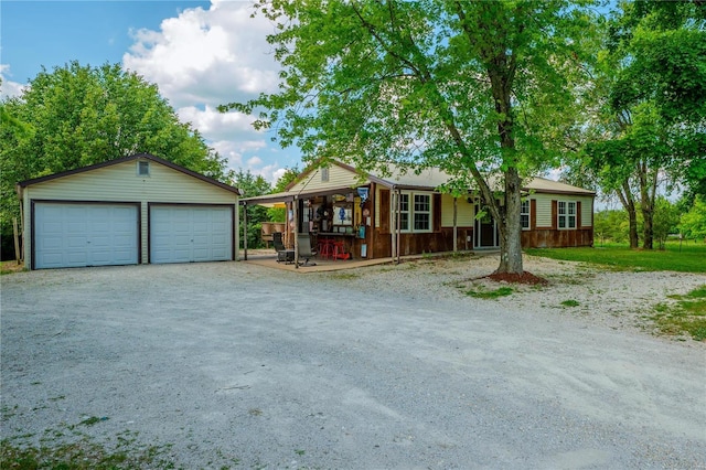 view of front of property with a garage and an outdoor structure