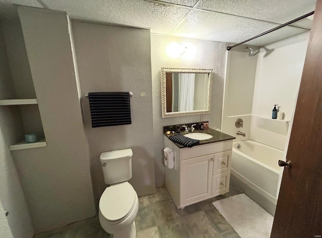 full bathroom featuring vanity, a drop ceiling, toilet, and shower / bath combination