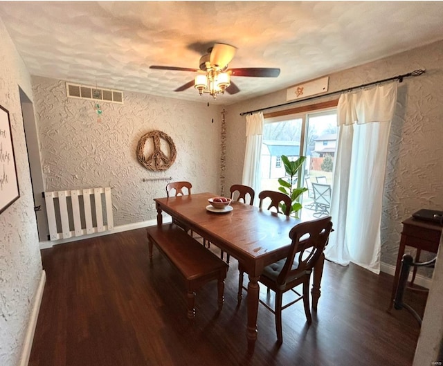 dining area featuring dark wood-type flooring and ceiling fan