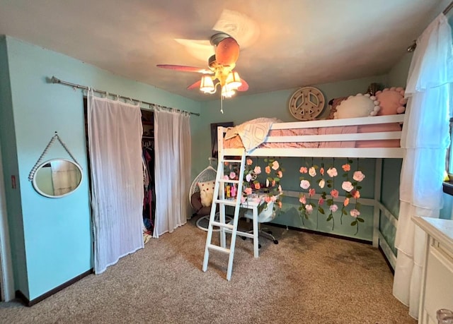 carpeted bedroom featuring ceiling fan and a closet