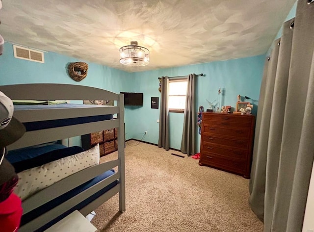 carpeted bedroom with a textured ceiling