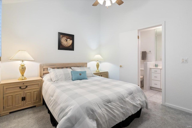 carpeted bedroom featuring connected bathroom and ceiling fan