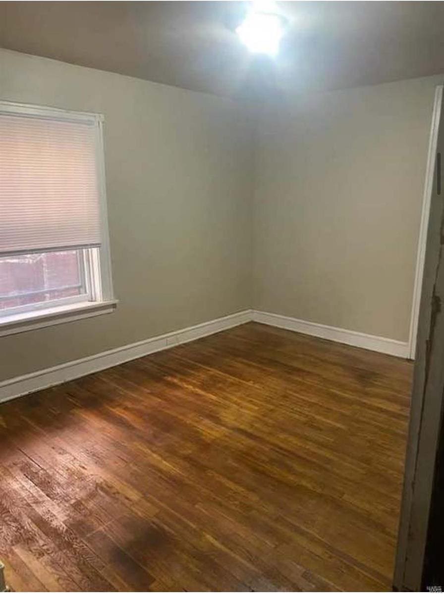 unfurnished room with dark hardwood / wood-style floors