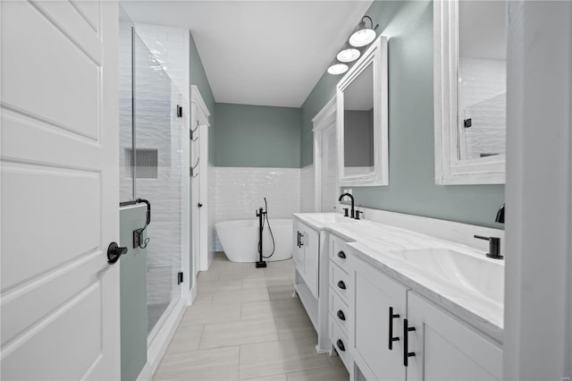 bathroom featuring tile walls, vanity, and plus walk in shower