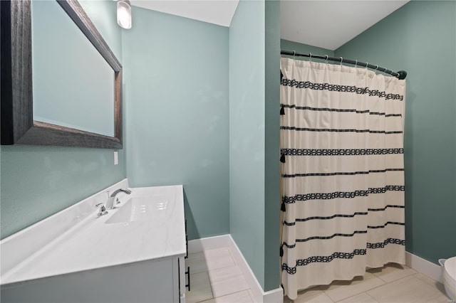 bathroom with walk in shower, vanity, toilet, and tile patterned flooring