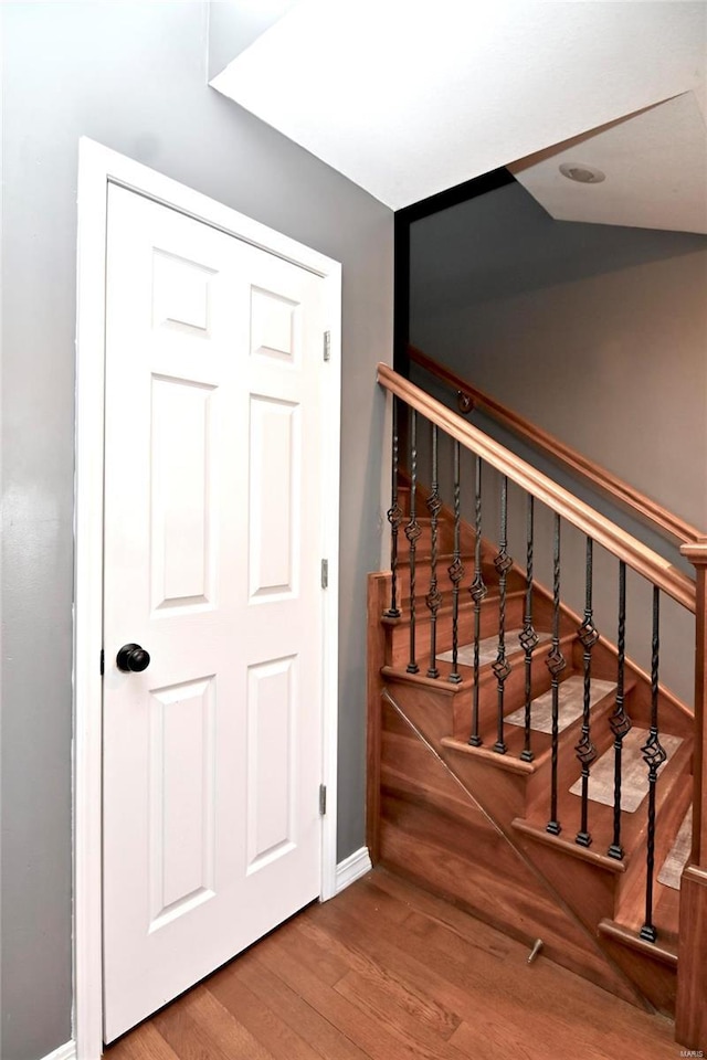 stairs featuring hardwood / wood-style flooring