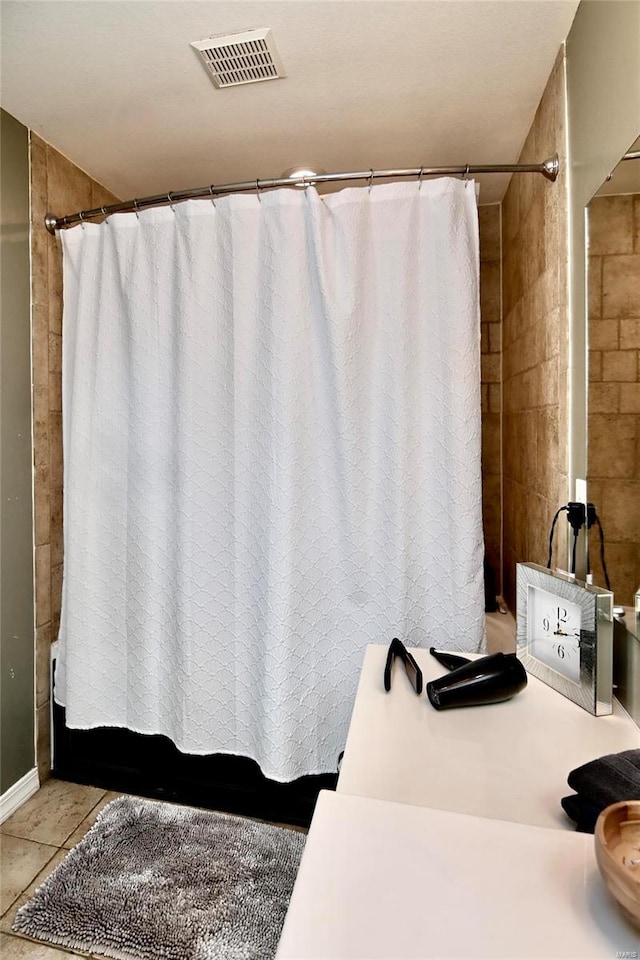 bathroom with tile patterned floors