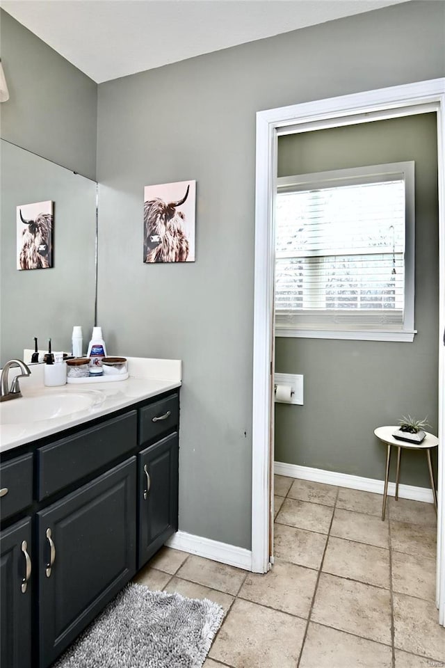 bathroom with tile patterned flooring and vanity