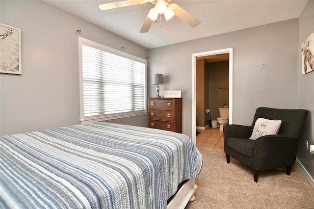 carpeted bedroom with connected bathroom and ceiling fan