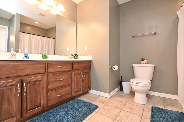 bathroom featuring vanity, toilet, and tile patterned flooring