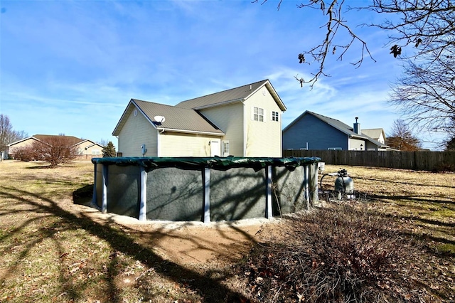 view of side of home with a covered pool