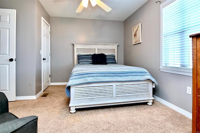 bedroom featuring ceiling fan and light colored carpet