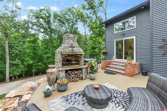 view of patio / terrace with an outdoor stone fireplace