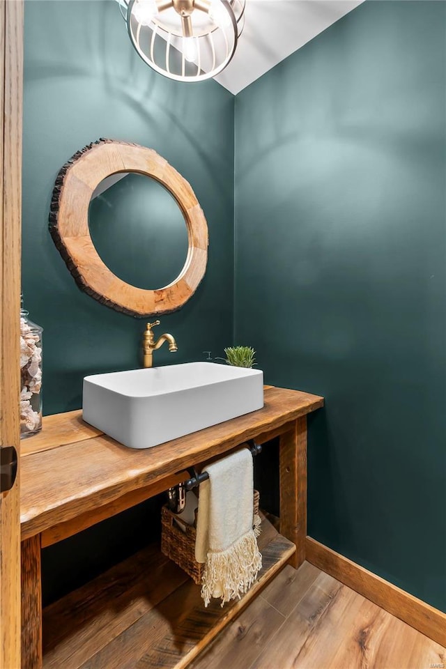 bathroom with wood-type flooring and sink