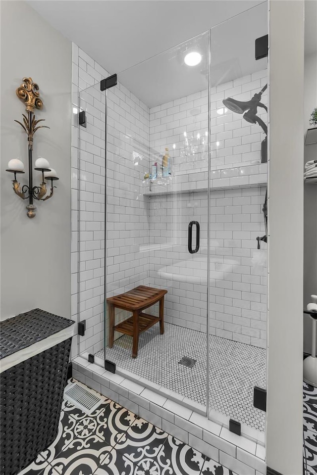 bathroom with tile patterned floors and walk in shower