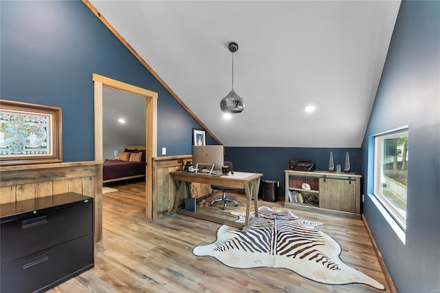 office with lofted ceiling and light hardwood / wood-style floors