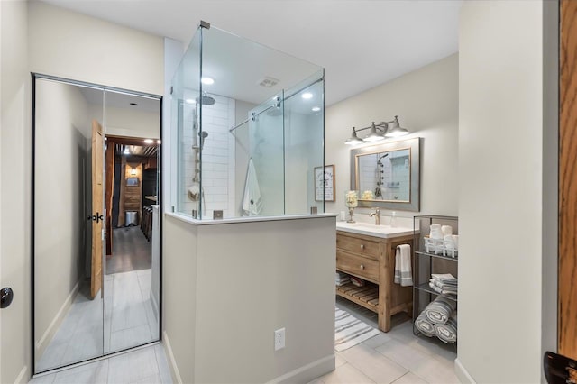 bathroom featuring vanity, tile patterned floors, and walk in shower