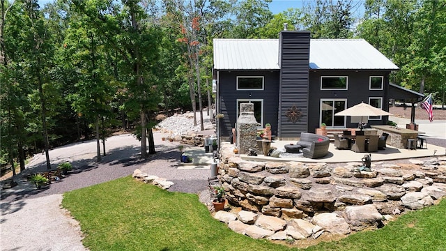 view of front facade featuring a fireplace and a patio area