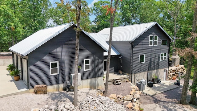 back of house featuring central AC