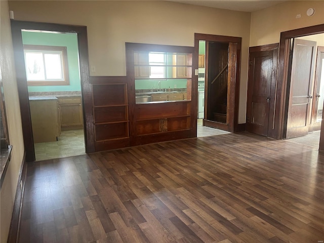 unfurnished bedroom with dark wood-type flooring and sink