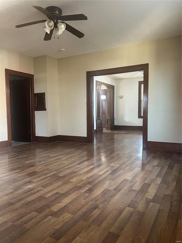 unfurnished room featuring ceiling fan, a textured ceiling, and dark hardwood / wood-style flooring